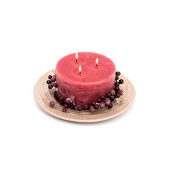 A large candle on a ceramic plate isolated on white background