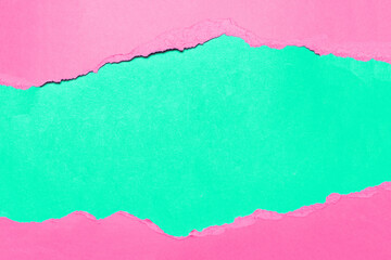 Natural background of torn pink textured paper on background of green.