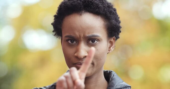 Afro american girl annoyed woman dismissively shaking her finger showing prohibition symbol making disagreement restriction gesture saying no, expresses negative attitude, refusal discontent concept