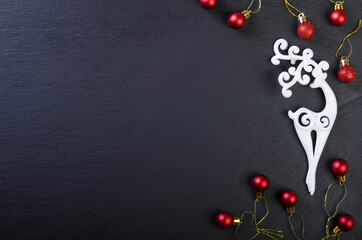 Christmas decoration. White deer and red balls.