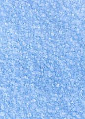 Winter snowy vertical background with snow crystals. Copy space, textured frozen surface, natural background, wallpaper