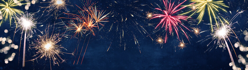 Silvester background banner panorama long- firework on rustic dark blue night sky texture