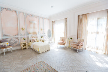 Luxurious expensive interior design of the children's room in the old Baroque style in beige colors