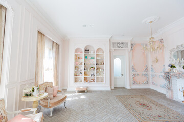 Luxurious expensive interior design of the children's room in the old Baroque style in beige colors