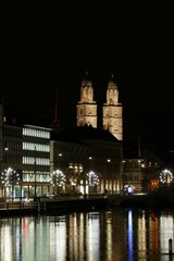 Fototapeta premium View from Rudolf-Brun-Brücke towards Grossmünster at Night, Zurich, Switzerland