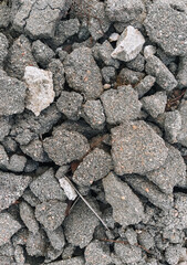Texture, the background of the destroyed, cracked in pieces of gray asphalt.