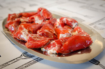 Delicious homemade stuffed peppers. Red peppers stuffed with mayonnaise and cod.