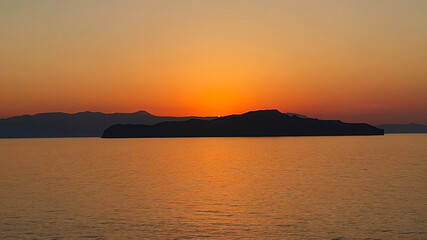 Colorful sunset over the water on Crete, Greece.