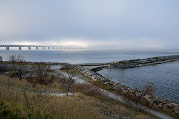 A bridge in fog. Blue ocean and mist in the background. Picture from the bridge connecting Malmo, Sweden with Copenhagen, Denmark