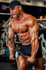 Fototapeta na wymiar Body Builder Exercise at the Gym. Hard Core Bodybuilding Workout