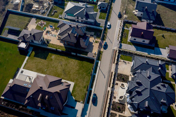 aerial view of houses on Ukraine housing estates, some with building on roof panels