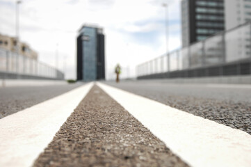 Shallow depth of field (selective focus) image with details from the asphalt on an empty highway.
