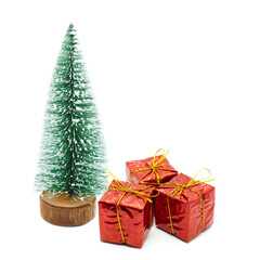 Three red gift boxes under the fir tree isolated on white background. Happy New Year and Marry Christmas concept.