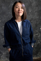 Beautiful korean woman dressed in jumpsuit studio portrait.