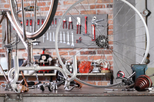 vintage bicycle in garage workshop on the workbench with tools, diy and repair concept