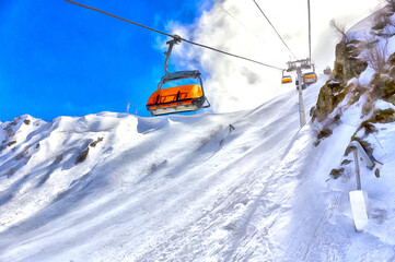 Fototapeta na wymiar Beautiful winter mountain landscape at ski resort with elevato