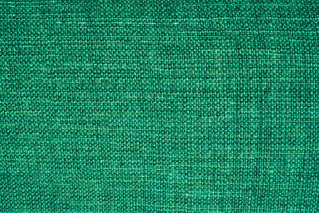 Linen dense fabric pattern of green color for curtains design or internal wall decoration of a modern building with vibrant shiny material. High quality photo