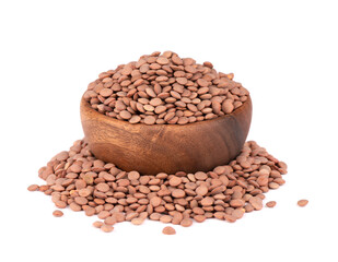 Brown lentils in wooden bowl, isolated on white background.