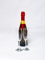 Bottle champagne and two glasses on white background.