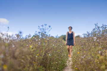 woman in field walking and relaxing