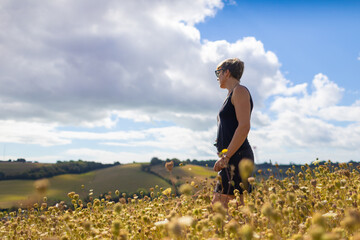 Fototapeta premium woman in field walking and relaxing