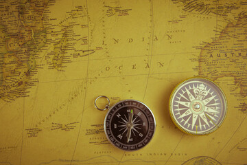 Compasses on old map of the world. Journey and discovery concept