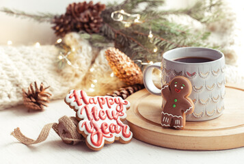 Obraz na płótnie Canvas Christmas composition with beautiful cup and gingerbread cookies with happy new year wishes.