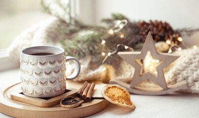 Obraz na płótnie Canvas Beautiful cup with hot drink close up on background of christmas decor with bokeh lights.