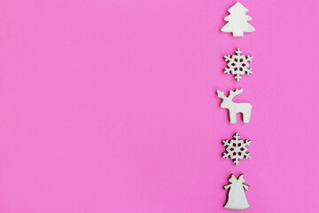 Wooden Christmas toys on pink background