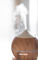 Modern oil aroma diffuser close up on a blurred background.