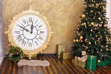 Christmas decoration with vintage clock. Time to New Year, interior with artificial fer-tree, big clock, toys and soft armchair. Brown colors and wooden room.  Comfort home. Christmas presents