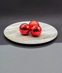 THREE BALLS OF CHRISTMAS TREE ON A PLATE