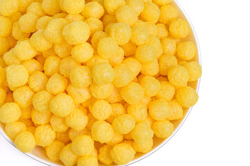 Corn flakes on a white. Cheese Corn balls in a large white bowl on a light background, Cinema or Beer snack.