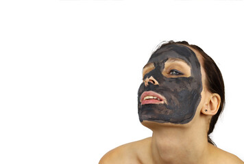 Portrait of an attractive girl in a clay cosmetic mask. Spa procedures