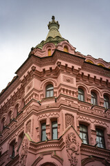 Fototapeta premium Pink and red historical building Bazin House in Russian style. Decorative facade with turrets, windows, stucco. Saint-Petersburg, Russia