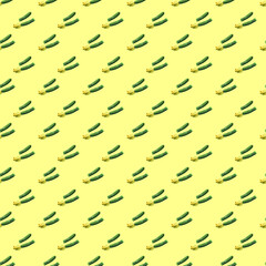 Seamless pattern of young green zucchini  on a yellow background