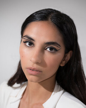 female model posing on white background