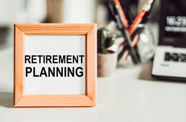 Wooden frame with office background with text - RETIREMENT PLANNING.