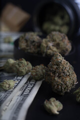 marijuana spilling out of a jar onto money
