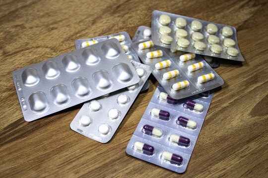 Colorful medicine capsules standing on the table