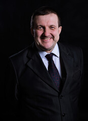 Middle aged solid man dressed in suit studio portrait