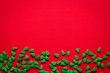 christmas red background with green christmas trees with place for text