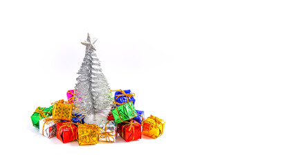 Festive snow background with small decorative Christmas tree and gifts