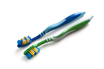 New, green and blue toothbrushes with multi-colored bristles