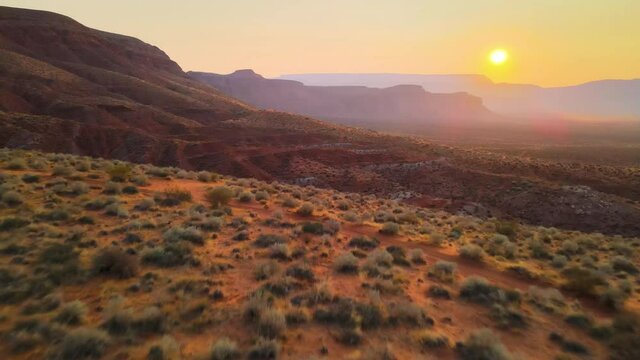 Cinematic aerial flyover of morning light in rugged desert in Southern Utah