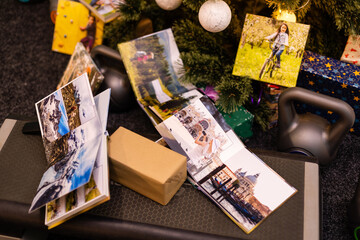 family photo album and weights for sports near the Christmas tree