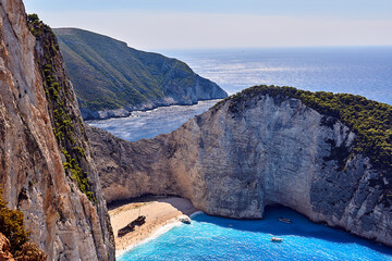 Rocky cliffs, shipwreck and people on the beach Navagio on Zakynthos island