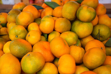 Background of ripe tangerines. Tangerines are sold at the market. Tangerines are new year's fruits, delicious and healthy citrus fruits.