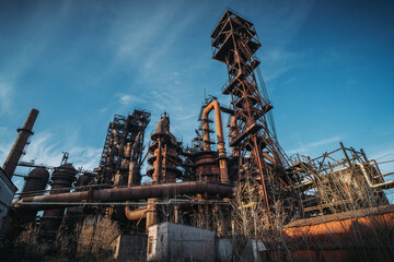 Blast furnace of metallurgical plant or chemical factory, large steel industrial buildings and pipelines.