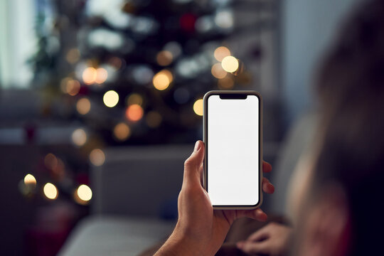 Man using smartphone during Christmas at home